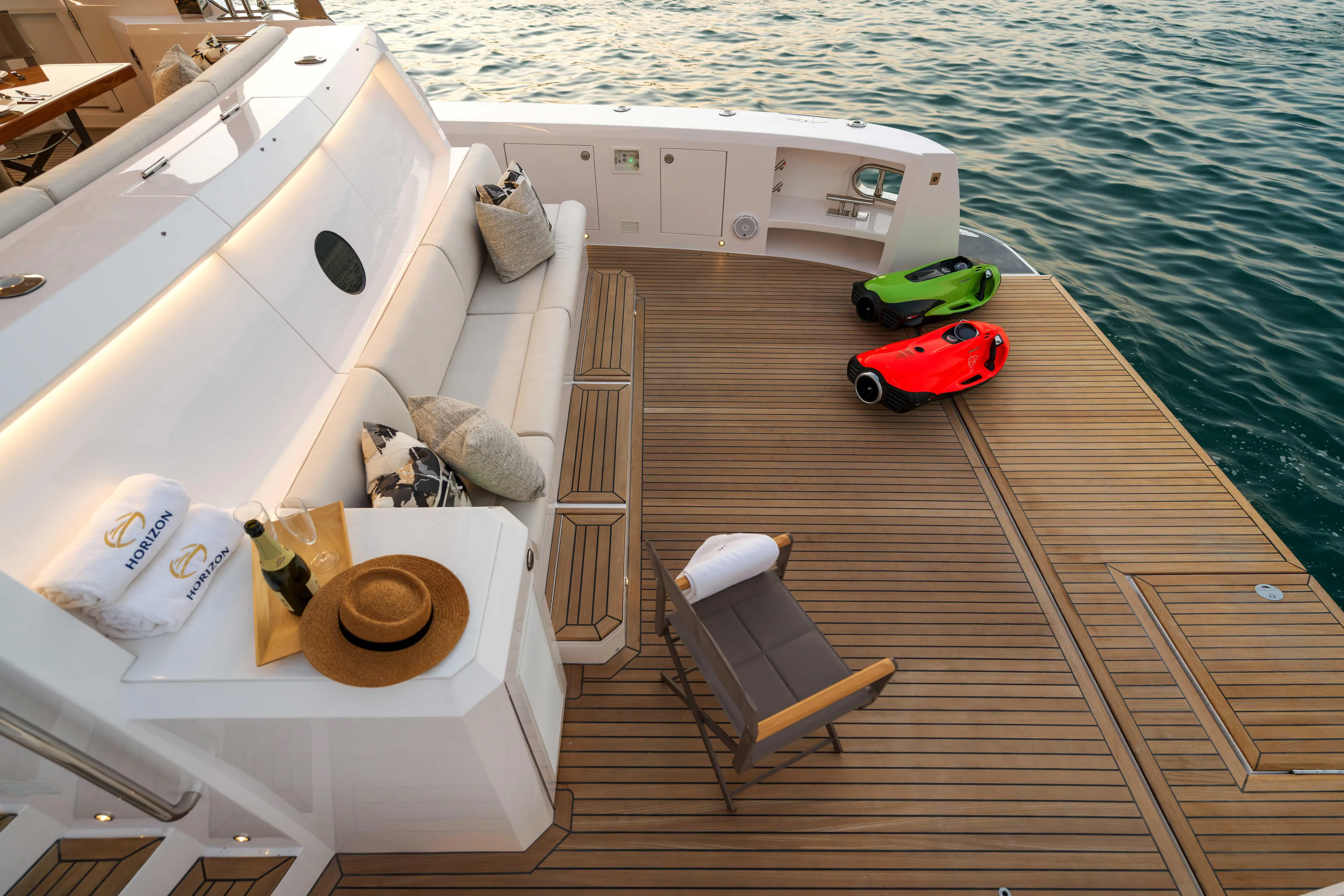 V77s-613 / Available Spring 2026 Yacht Photos Pics Luxurious Horizon V77S yacht deck with seating, sea scooters, and ocean view, 2026 model.