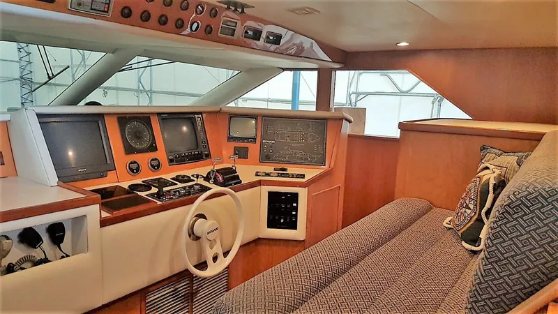 Golden Eagle Yacht Photos Pics Interior of 1989 Broward Raised Pilothouse MY with navigation equipment and seating area.