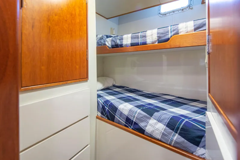 Golden Eagle Yacht Photos Pics Bunk beds in 1989 Broward Raised Pilothouse MY yacht cabin with wood paneling.