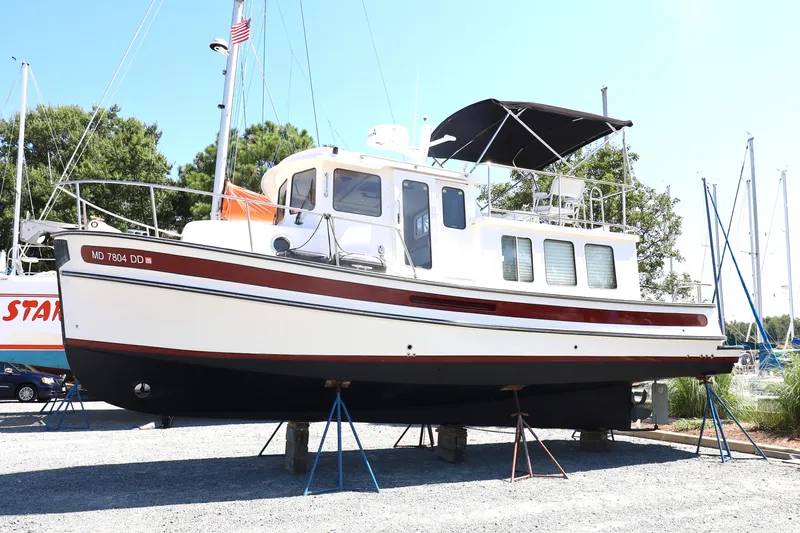 Edgin Yacht Photos Pics 2007 Nordic Tug 32 boat on stands in a marina setting.