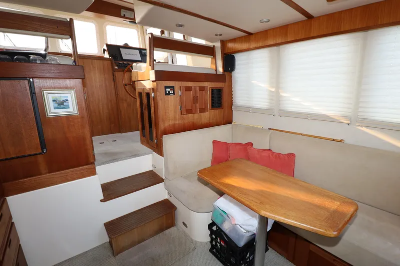 Edgin Yacht Photos Pics Cozy interior of 2007 Nordic Tug 32 with wooden accents and seating area.