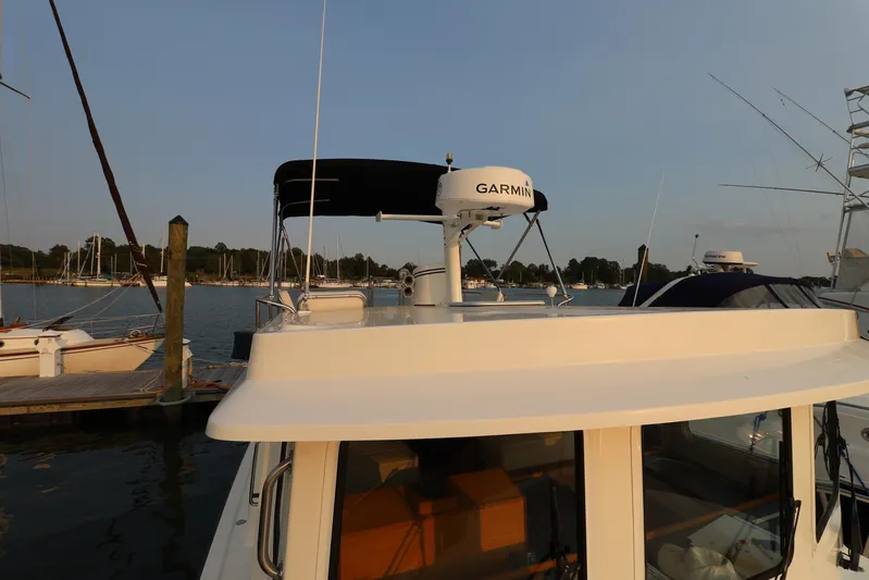 Edgin Yacht Photos Pics 2007 Nordic Tug 32 docked, featuring Garmin radar, with scenic marina backdrop.