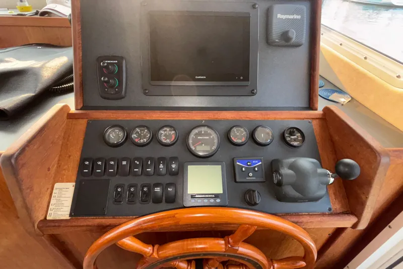 Edgin Yacht Photos Pics 2007 Nordic Tug 32 helm with gauges, controls, and navigation equipment.