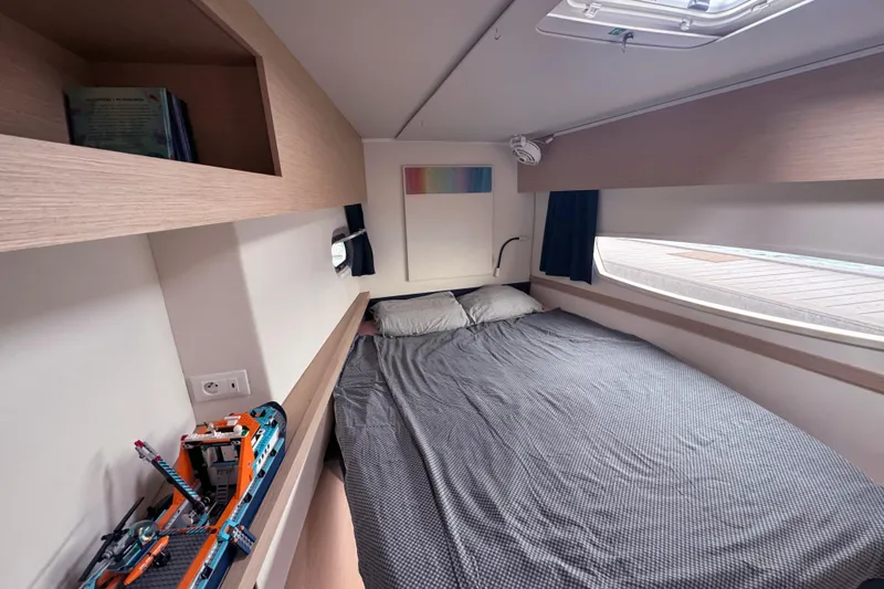 Katla Yacht Photos Pics Cozy cabin interior of 2018 Fountaine Pajot Helia 44 Evolution with bed and model ship.