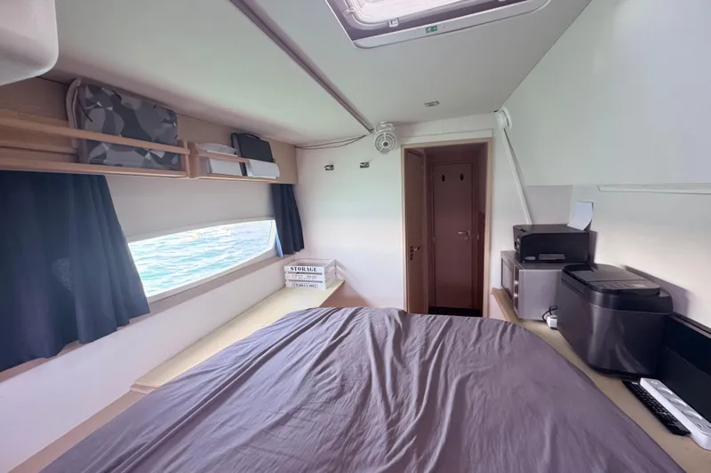 Katla Yacht Photos Pics 2018 Fountaine Pajot Helia 44 Evolution cabin interior with bed, window, and storage.
