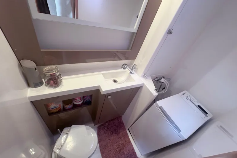 Katla Yacht Photos Pics Bathroom interior of 2018 Fountaine Pajot Helia 44 Evolution yacht, featuring sink and washing machine.