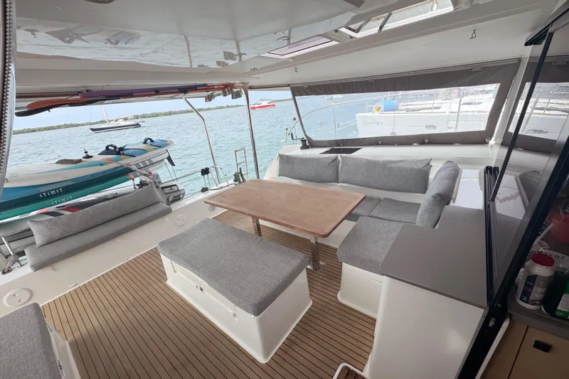 Katla Yacht Photos Pics 2018 Fountaine Pajot Helia 44 Evolution yacht interior with seating and table, overlooking the water.