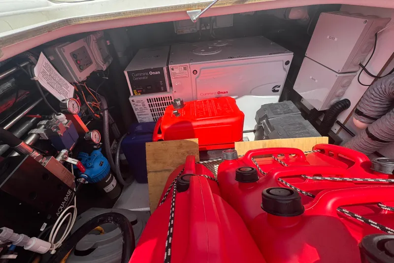 Katla Yacht Photos Pics Engine room of 2018 Fountaine Pajot Helia 44 Evolution with Cummins Onan generator and red fuel containers.