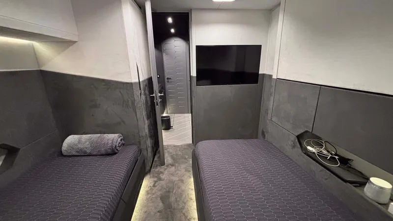  Yacht Photos Pics Interior of 2022 Tecnomar Lamborghini 63 yacht with twin beds and modern decor.