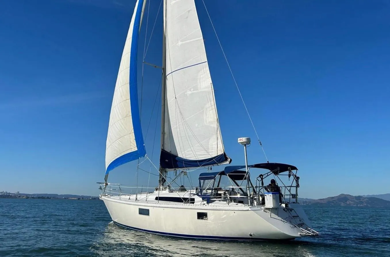 Sailing yacht Gib'Sea 126, 1985 model, cruising on open water under clear blue skies.