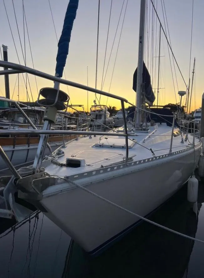 1985 Gib'Sea 126 sailboat docked at sunset in a marina.