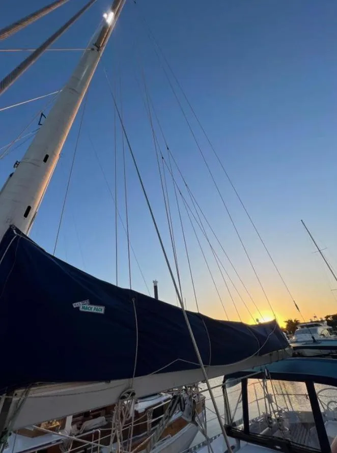 1985 Gib'Sea 126 sailboat at sunset, docked with mast and rigging visible.