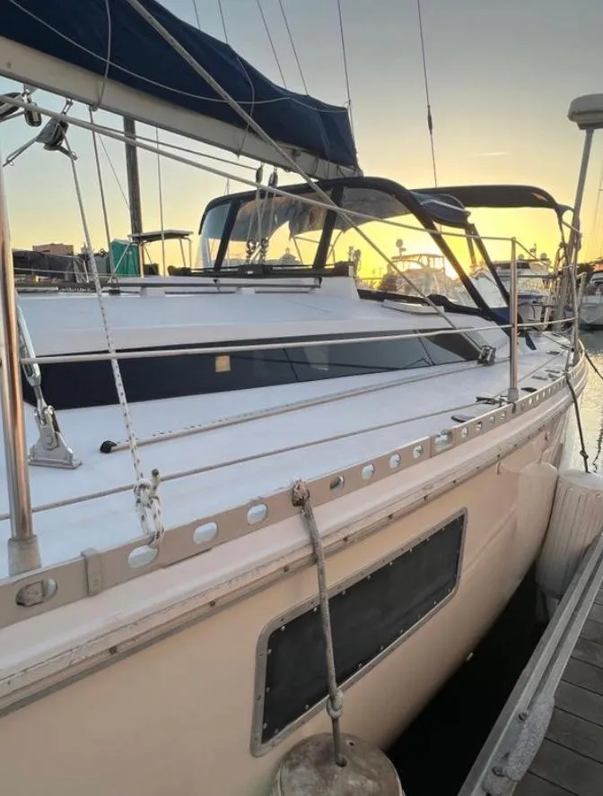 1985 Gib'Sea 126 sailboat docked at sunset, featuring sleek design and sturdy rigging.