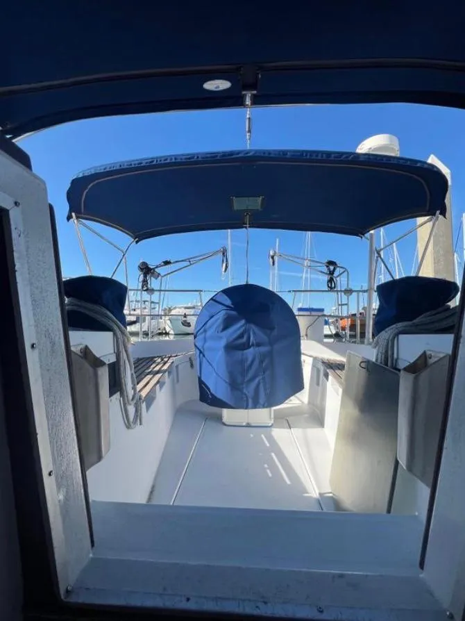 1985 Gib'Sea 126 sailboat cockpit with blue canopy and clear sky background.