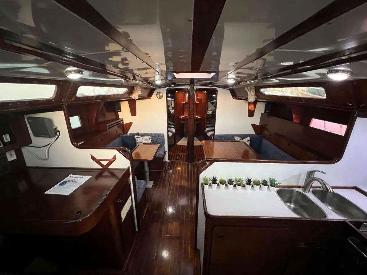 Interior of 1985 Gib'Sea 126 sailboat with wooden finishes and modern amenities.