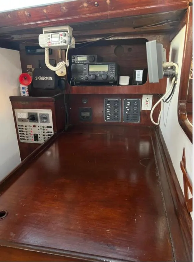 Navigation station of a 1985 Gib'Sea 126 sailboat with communication equipment.