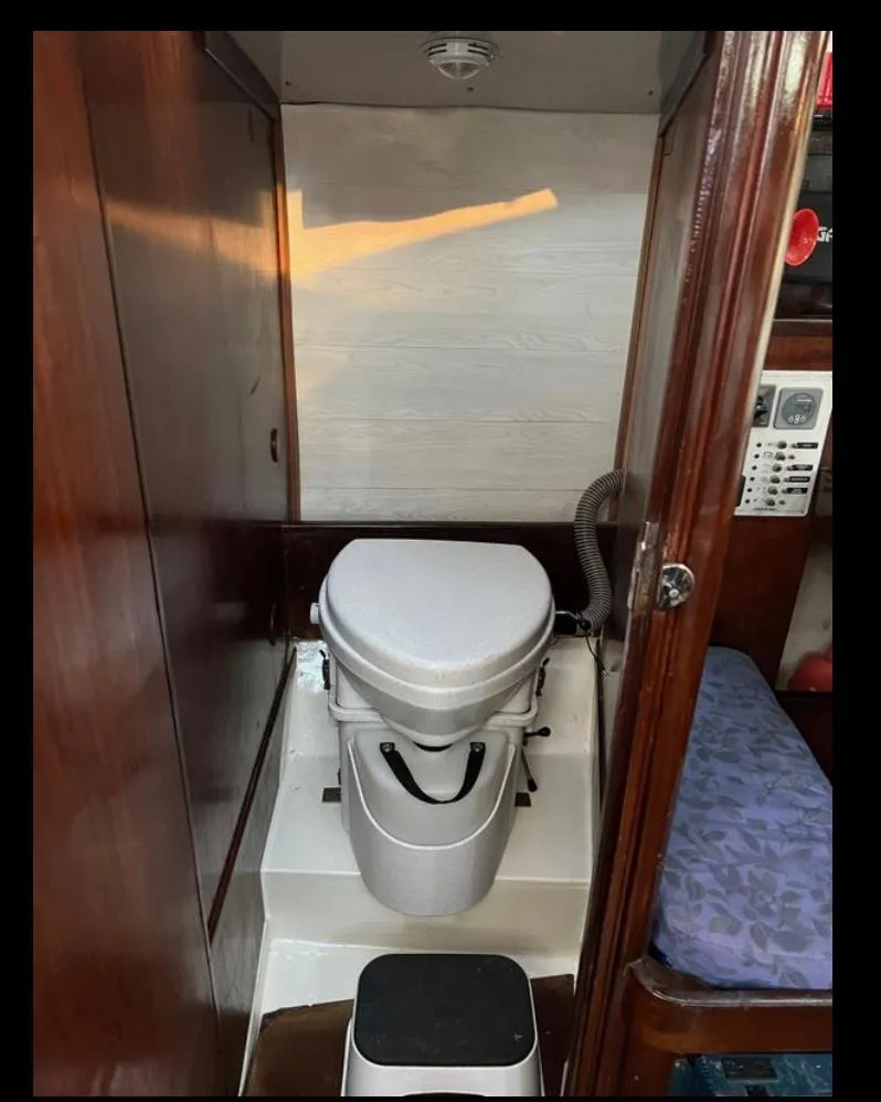 1985 Gib'Sea 126 yacht bathroom with compact marine toilet.