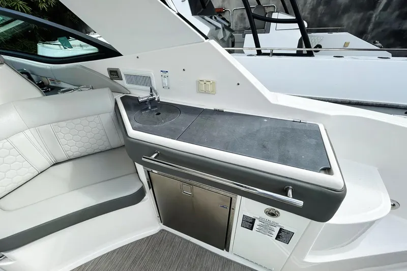  Yacht Photos Pics 2020 Sea Ray Sundancer 320 interior with kitchenette and seating area.