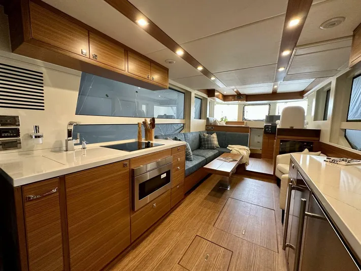  Yacht Photos Pics Luxurious interior of 2026 Outback Yachts Outback 50, featuring modern kitchen and seating area.