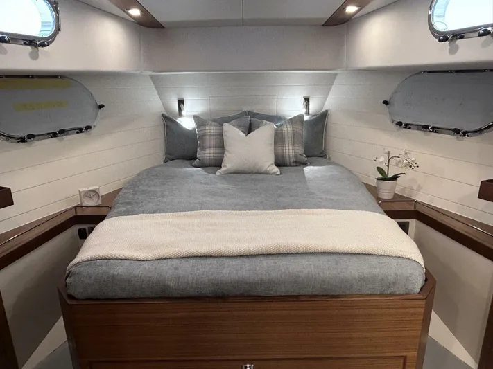  Yacht Photos Pics Luxurious cabin interior of 2026 Outback Yachts Outback 50 with cozy bedding and elegant decor.
