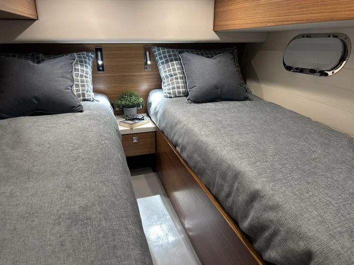  Yacht Photos Pics 2026 Outback Yachts Outback 50 cabin with twin beds, modern decor, and cozy lighting.