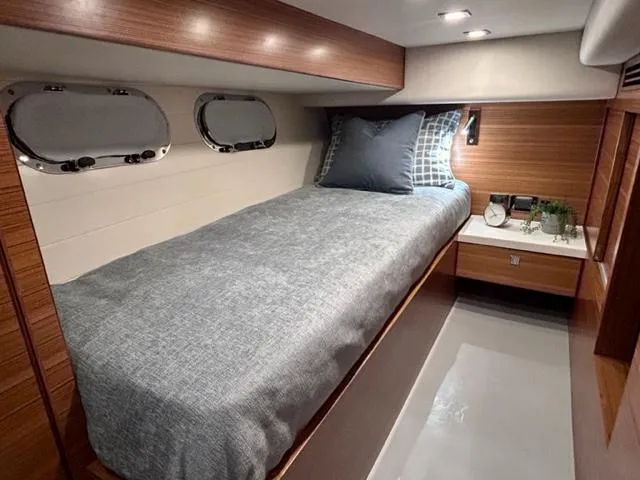  Yacht Photos Pics 2026 Outback Yachts Outback 50 cabin with single bed, modern decor, and porthole windows.