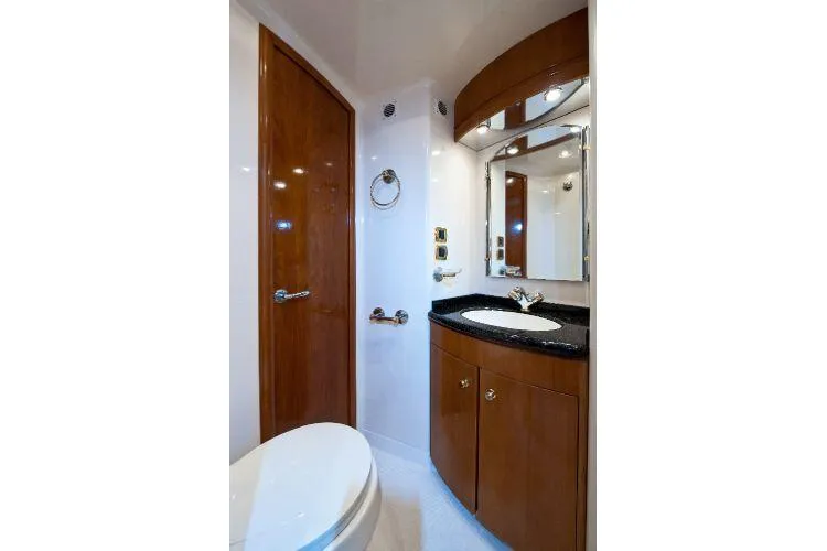 Size Matter's Yacht Photos Pics Luxurious bathroom in 2001 Carver 530 Voyager Pilothouse yacht with wood accents and modern fixtures.