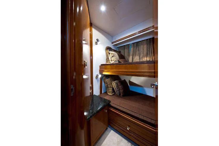 Size Matter's Yacht Photos Pics Interior of 2001 Carver 530 Voyager Pilothouse with cozy bunk beds and wooden finish.