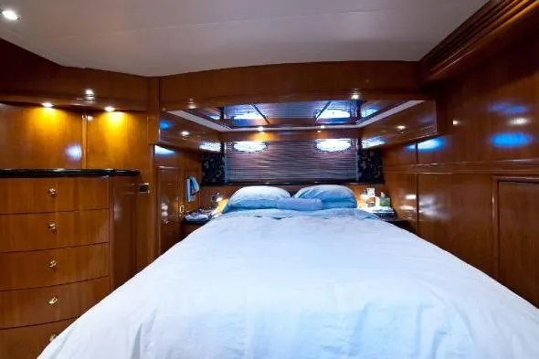 Size Matter's Yacht Photos Pics Luxurious bedroom interior of 2001 Carver 530 Voyager Pilothouse yacht with wood paneling.