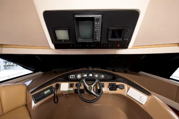 Size Matter's Yacht Photos Pics Pilothouse interior of 2001 Carver 530 Voyager, featuring steering wheel and navigation equipment.
