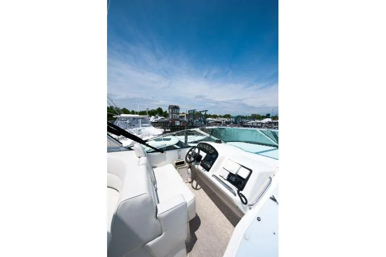 Size Matter's Yacht Photos Pics 2001 Carver 530 Voyager Pilothouse yacht interior with steering wheel and dashboard, docked at marina.