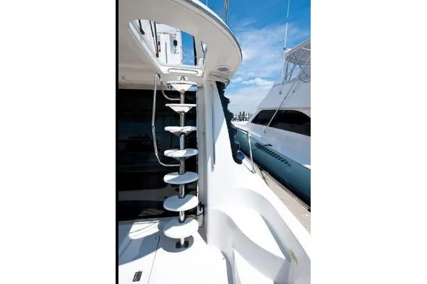 Size Matter's Yacht Photos Pics Staircase on 2001 Carver 530 Voyager Pilothouse yacht, docked under clear blue sky.