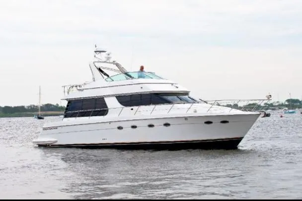 Size Matter's Yacht Photos Pics 2001 Carver 530 Voyager Pilothouse yacht on calm water.
