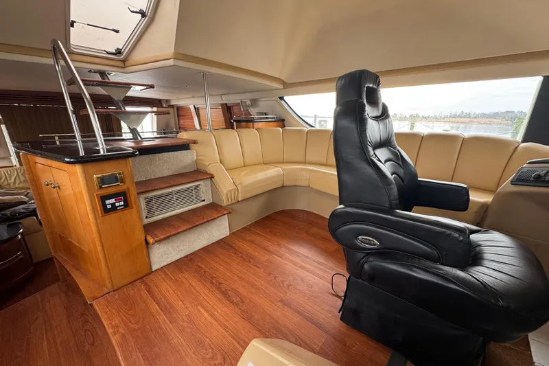Size Matter's Yacht Photos Pics Luxurious interior of 2001 Carver 530 Voyager Pilothouse with leather seating and wood accents.