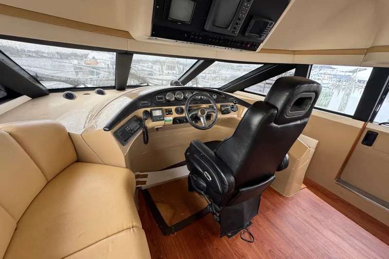 Size Matter's Yacht Photos Pics Pilothouse interior of 2001 Carver 530 Voyager, featuring helm and seating area.