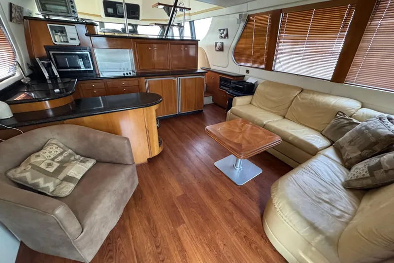 Size Matter's Yacht Photos Pics Interior of 2001 Carver 530 Voyager Pilothouse with wood flooring and modern furnishings.