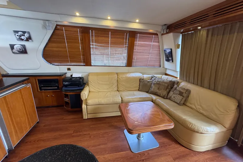 Size Matter's Yacht Photos Pics Luxurious interior of 2001 Carver 530 Voyager Pilothouse with leather seating and wooden accents.
