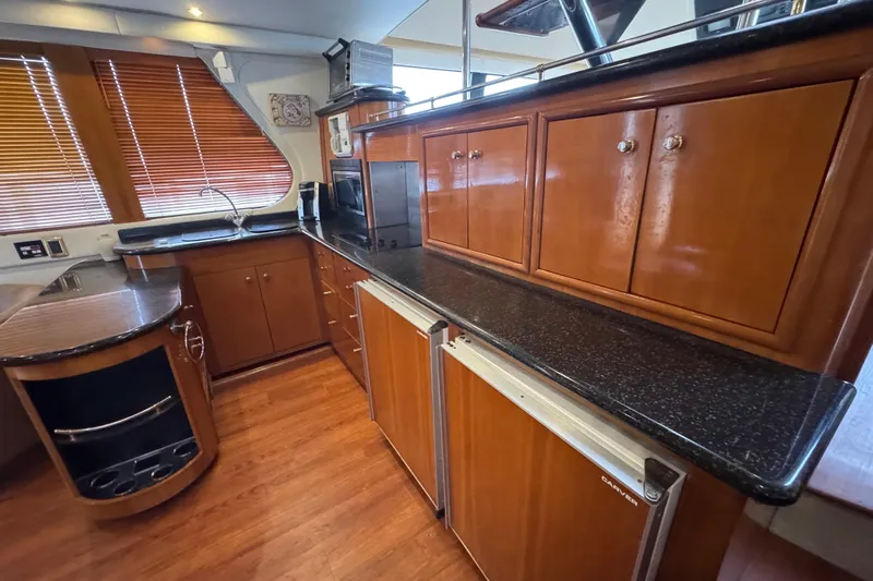 Size Matter's Yacht Photos Pics Luxurious kitchen interior of 2001 Carver 530 Voyager Pilothouse yacht with wood cabinetry.