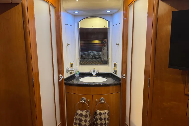 Size Matter's Yacht Photos Pics Luxurious bathroom in 2001 Carver 530 Voyager Pilothouse yacht with wood accents and modern fixtures.