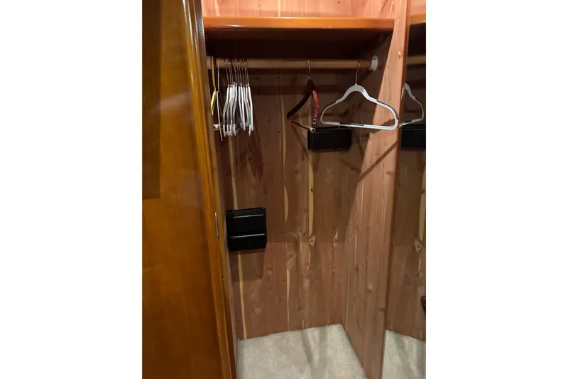 Size Matter's Yacht Photos Pics Wooden closet interior with hangers, inside a 2001 Carver 530 Voyager Pilothouse.