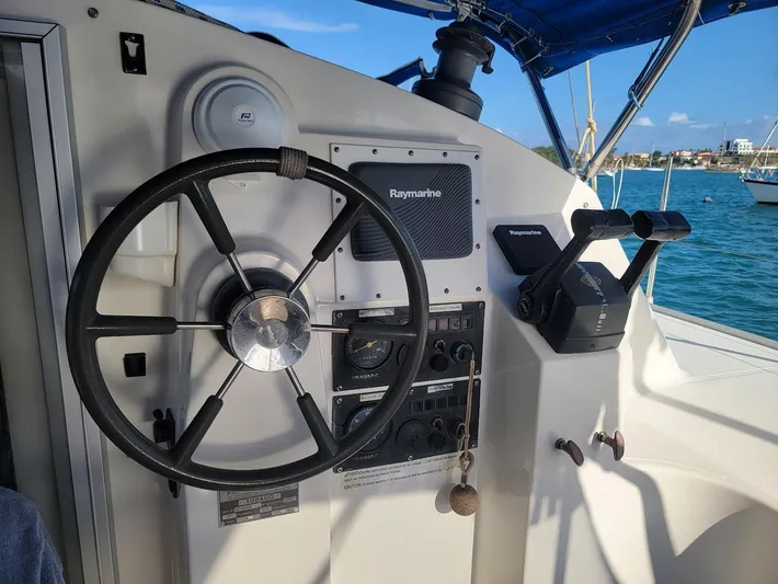 Cat Tales Yacht Photos Pics Steering wheel and controls of a 1996 Fountaine Pajot Tobago 35 catamaran.