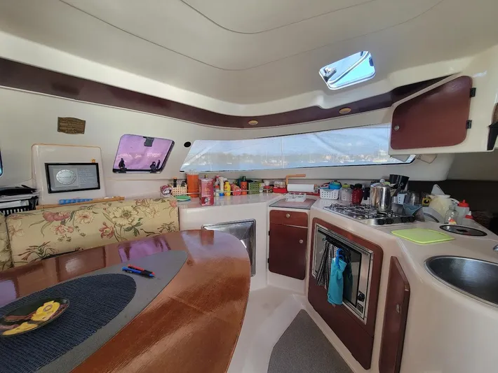 Cat Tales Yacht Photos Pics Interior of 1996 Fountaine Pajot Tobago 35 catamaran with kitchen and dining area.