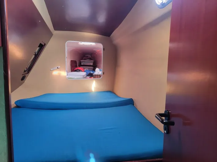 Cat Tales Yacht Photos Pics Cabin interior of 1996 Fountaine Pajot Tobago 35 with blue bedding.