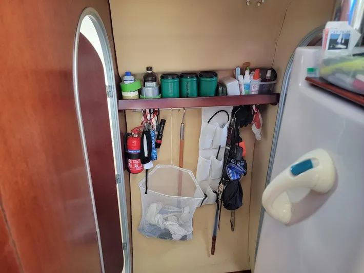 Cat Tales Yacht Photos Pics Interior storage area of a 1996 Fountaine Pajot Tobago 35 catamaran with organized shelves and tools.