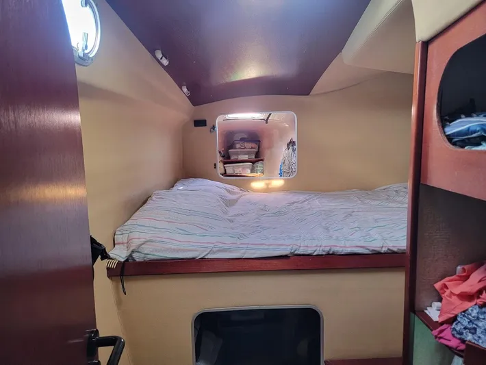 Cat Tales Yacht Photos Pics Cabin interior of 1996 Fountaine Pajot Tobago 35 catamaran with cozy bed and storage.