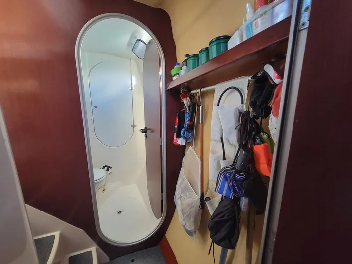 Cat Tales Yacht Photos Pics Interior of 1996 Fountaine Pajot Tobago 35 catamaran, featuring a compact bathroom and storage area.