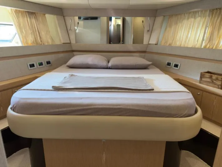  Yacht Photos Pics Luxurious bedroom interior of 2011 Ferretti Yachts 570 with elegant bedding and natural light.