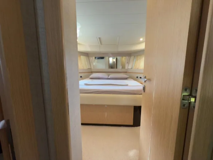  Yacht Photos Pics Luxurious bedroom interior of 2011 Ferretti Yachts 570, featuring elegant wood finishes.