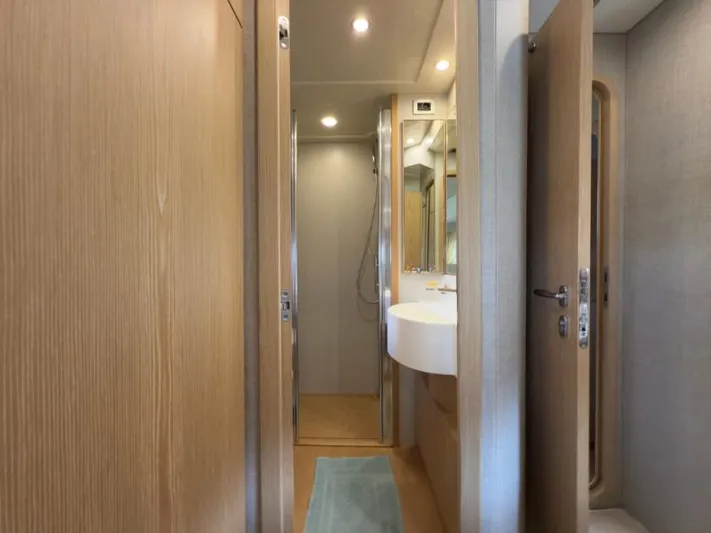  Yacht Photos Pics Interior of 2011 Ferretti Yachts 570 bathroom with modern fixtures and wooden accents.