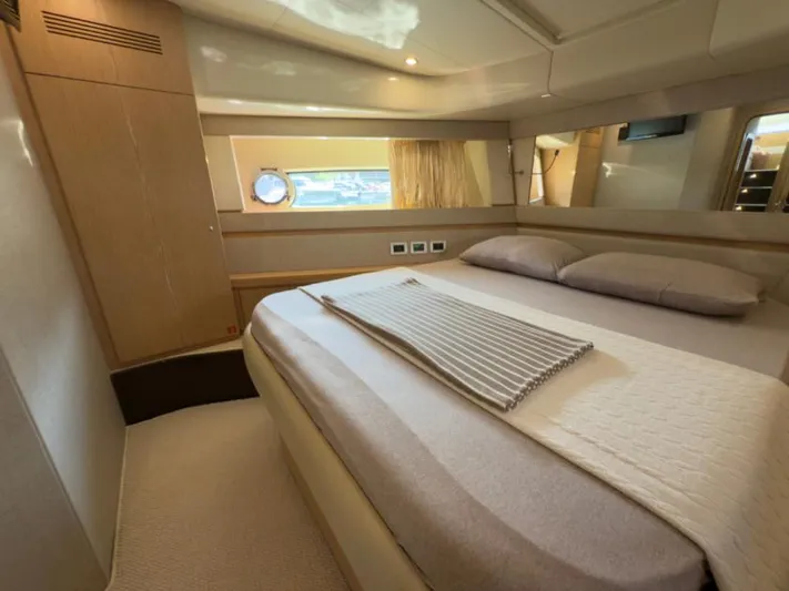  Yacht Photos Pics Luxurious bedroom interior of 2011 Ferretti Yachts 570 with modern design and cozy bedding.